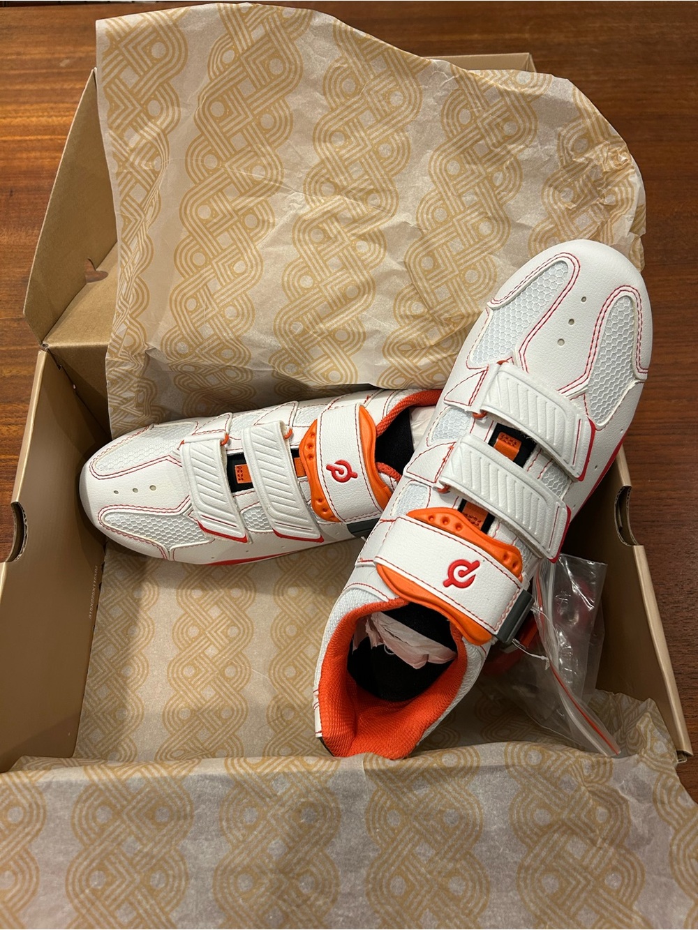 White and Orange Peloton Shoes
